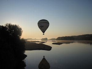 Hot air balloon over Loire Valley at daybreak